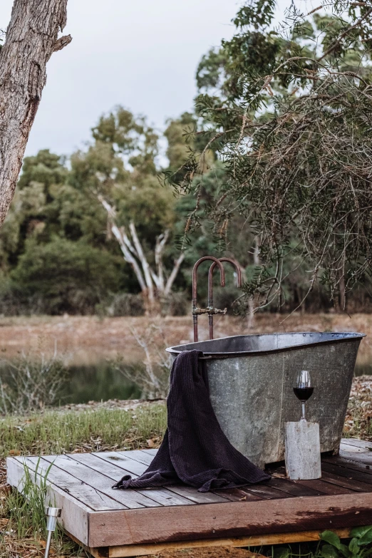 a concrete tub with the cover pulled back and a black towel on it