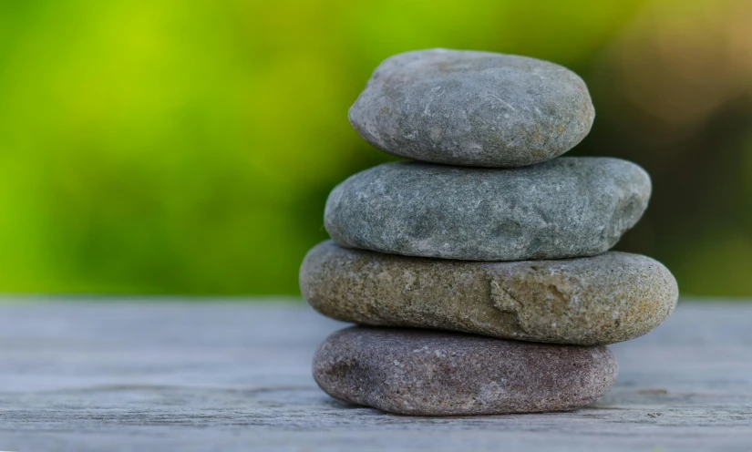 several rocks piled together in the shape of three stacked to the side