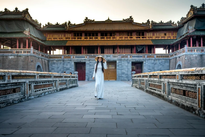 a woman with an umbrella standing on a bridge