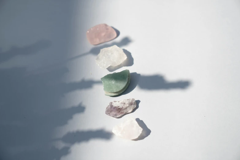 various small stones laying on a white surface