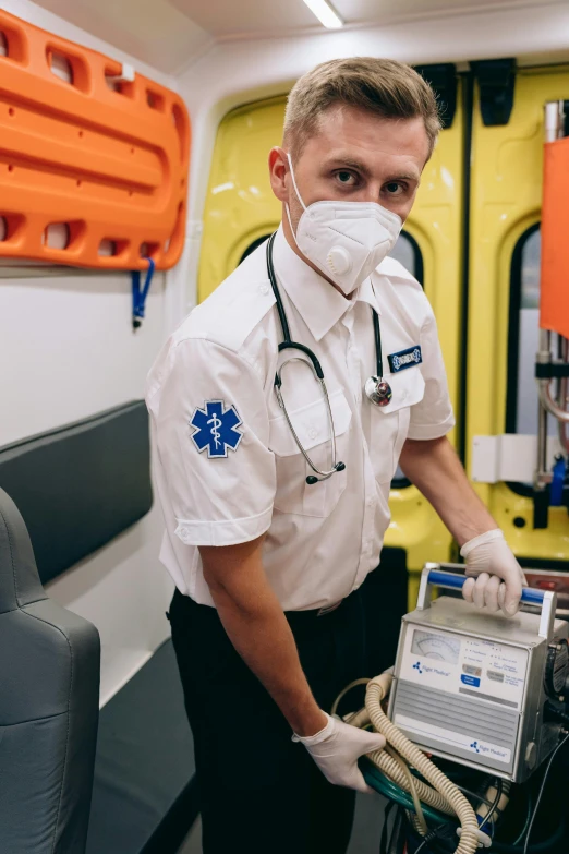 a male doctor in a white coat and face mask