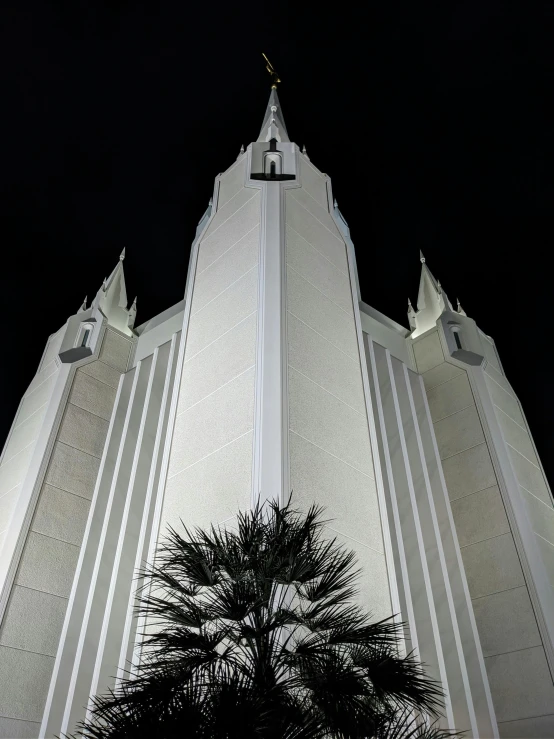 a building with two towers and plants on the outside