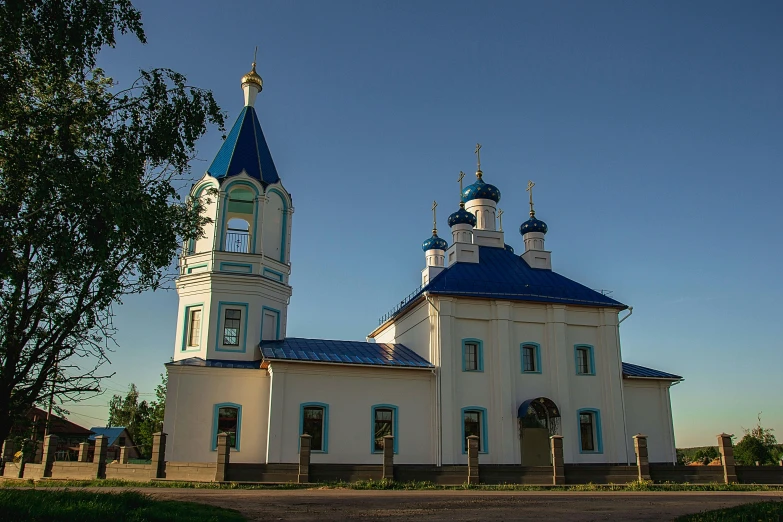 there is a large white church with blue domes