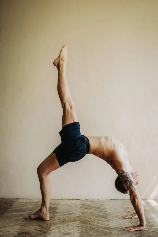 the man is practicing a yoga pose on the floor