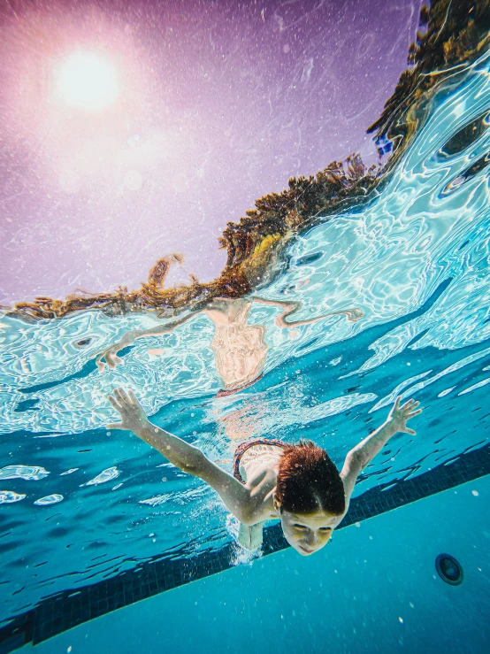 a person swimming under the water near the ground