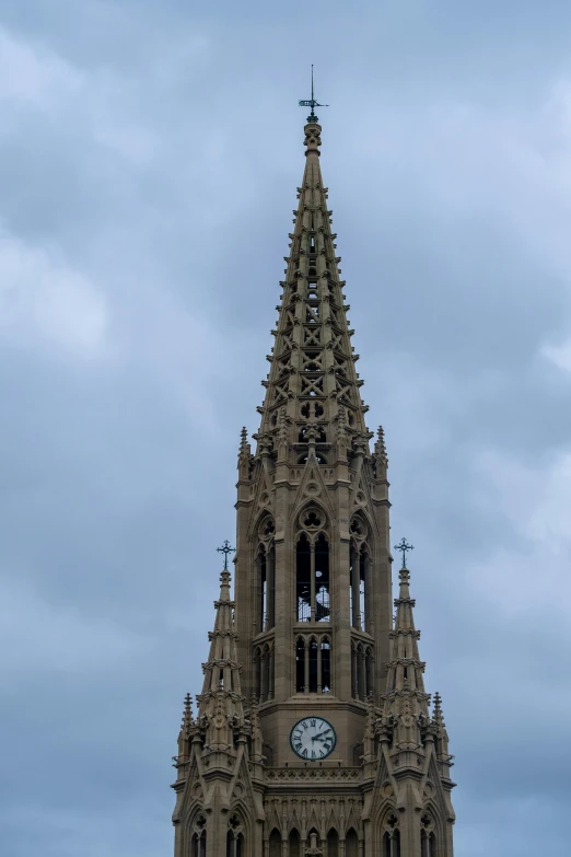 a very large clock tower with a sky background