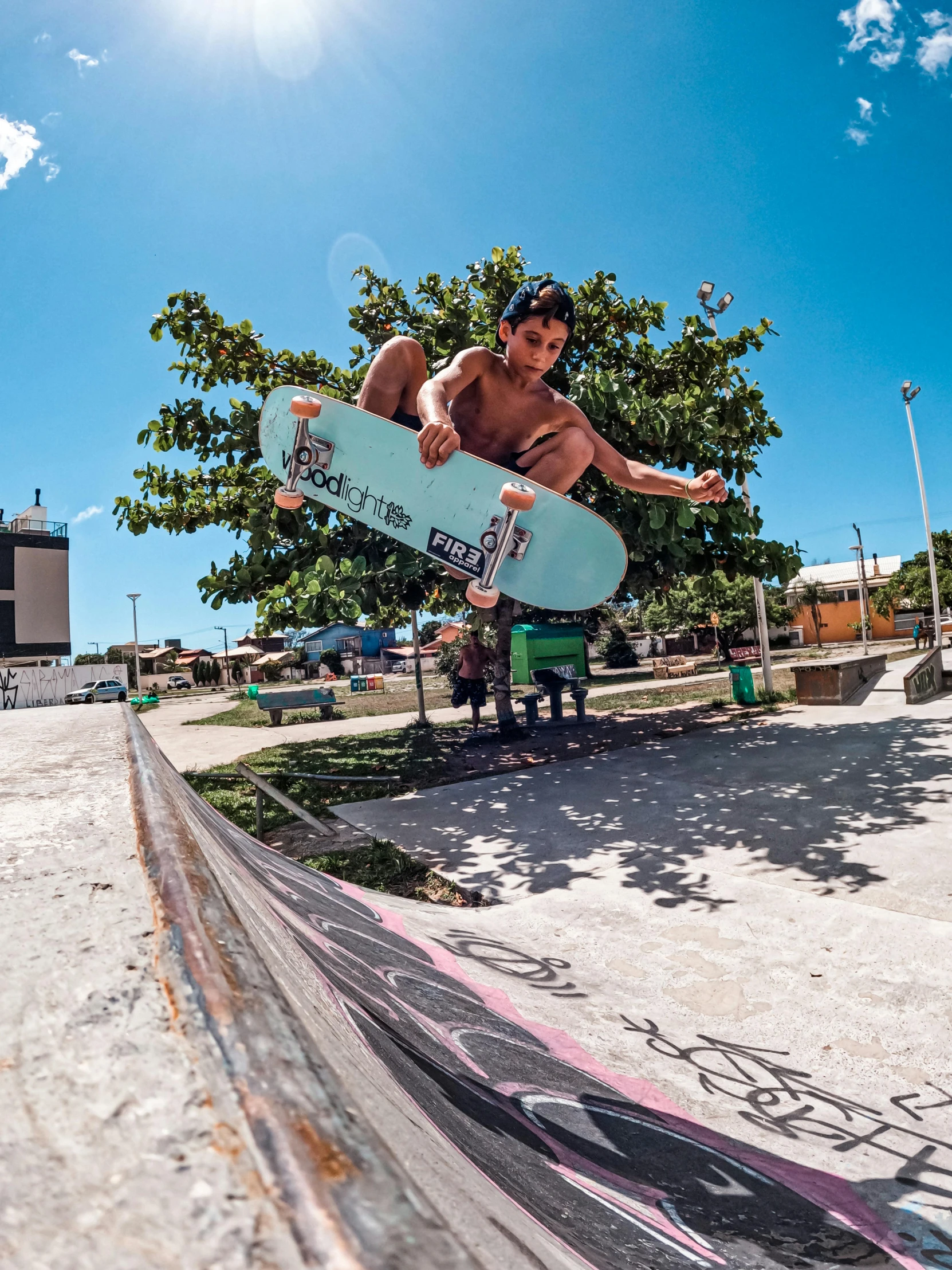 a man in the air on a blue skateboard