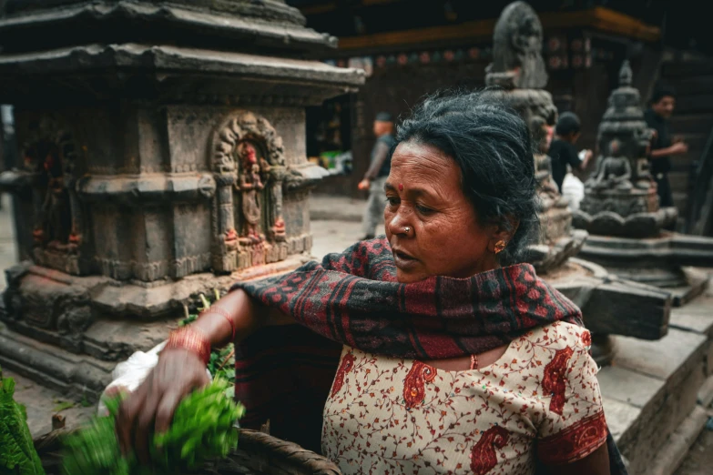 a woman is preparing to leave an intricate shrine