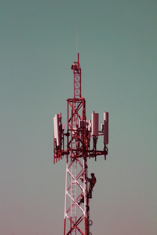 a tall tower that has several cell towers on top of it