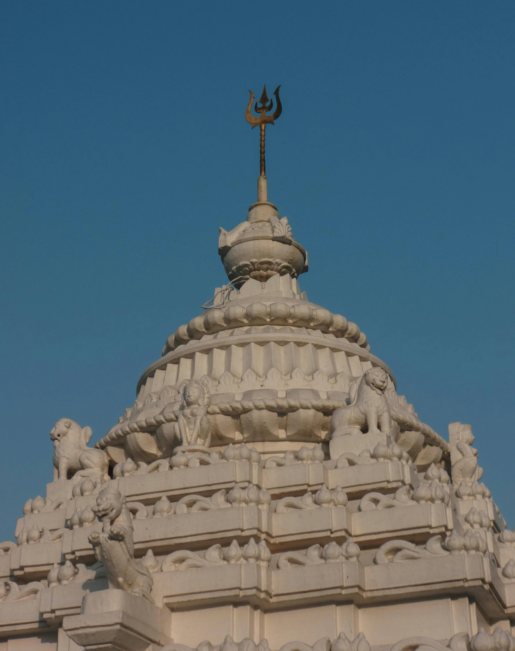 a building has a cross and weather vane on top