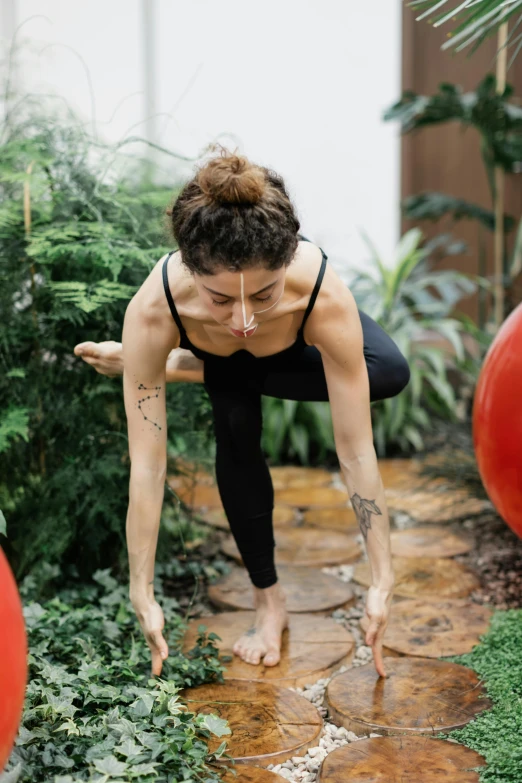 a woman in a yoga outfit standing over her knees