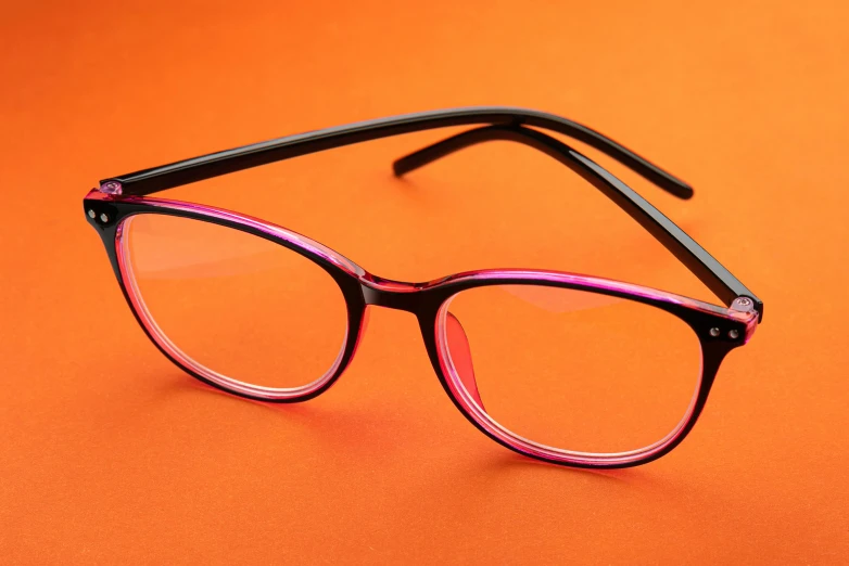 a pair of glasses on an orange background