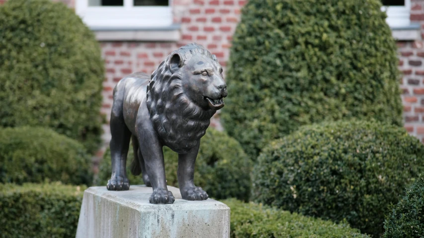 a lion statue is on display outside a brick building