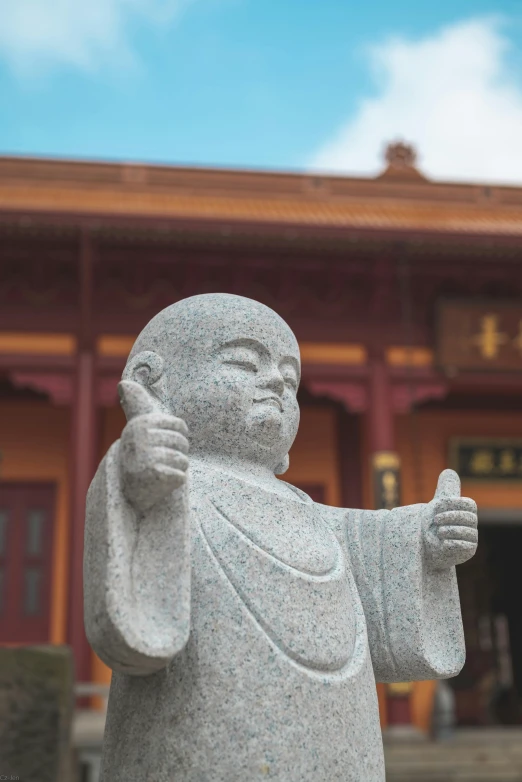 a statue standing in front of a building