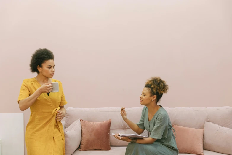 two women sitting on a couch eating