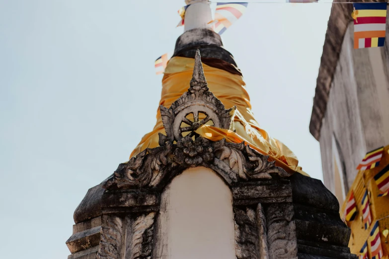 a large tower with some flags flying above it