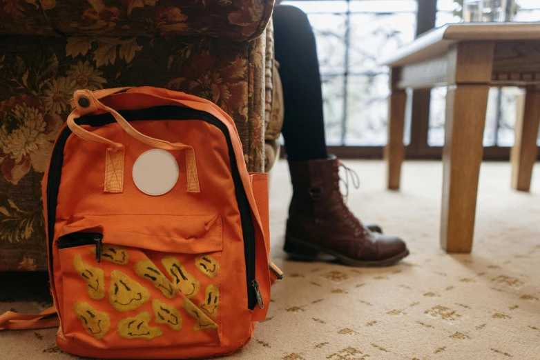 the interior of someones house, with a bag that looks like an orange backpack on the floor