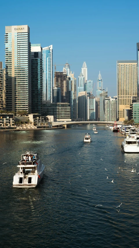 several boats are floating on a large river