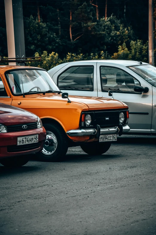 several cars parked in a lot near one another