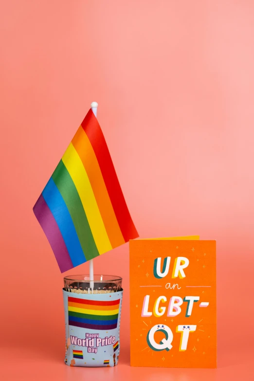 an up close picture of a small candle in front of a sign and flag