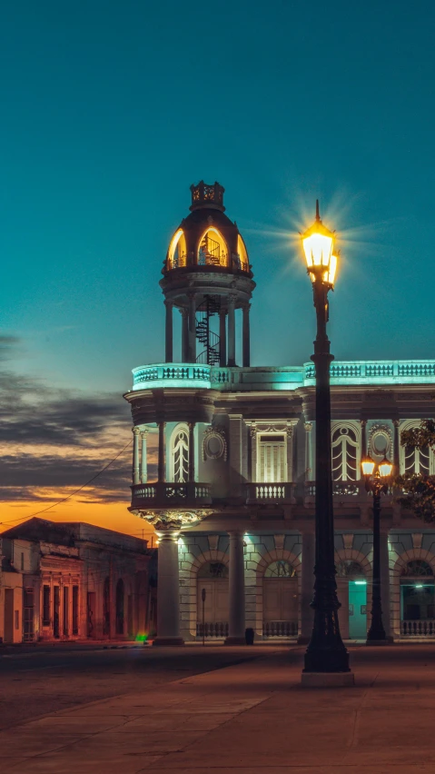 an old white building with a clock tower on it