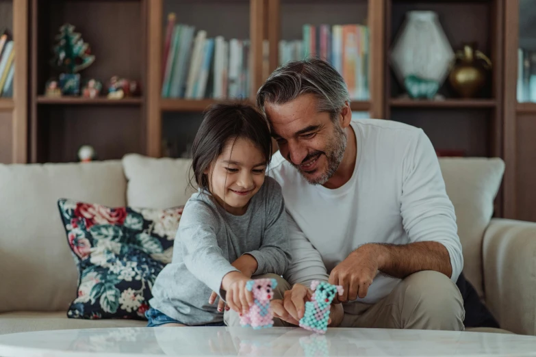 a man and a little girl playing with a game