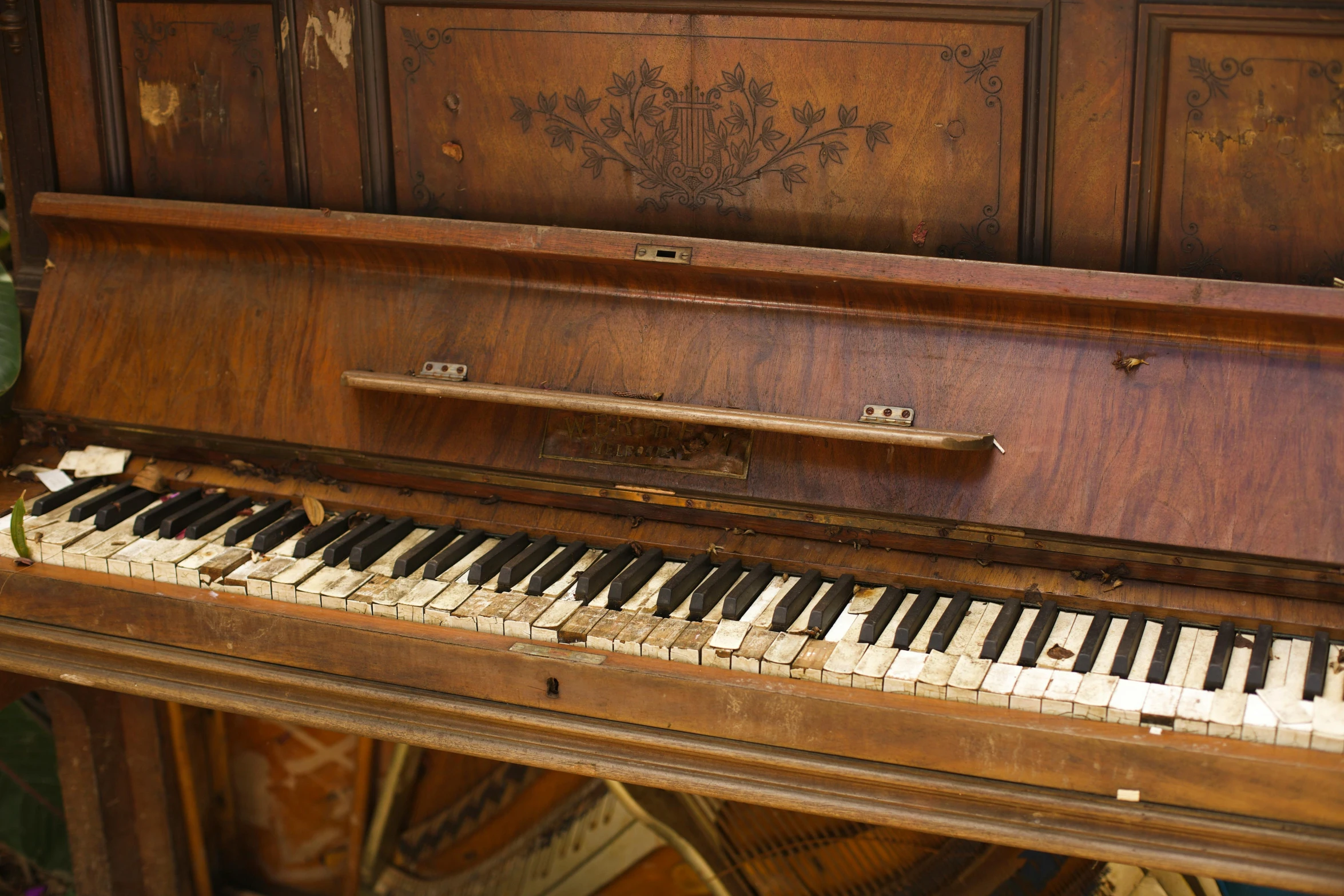 an old wooden upright piano with its top missing