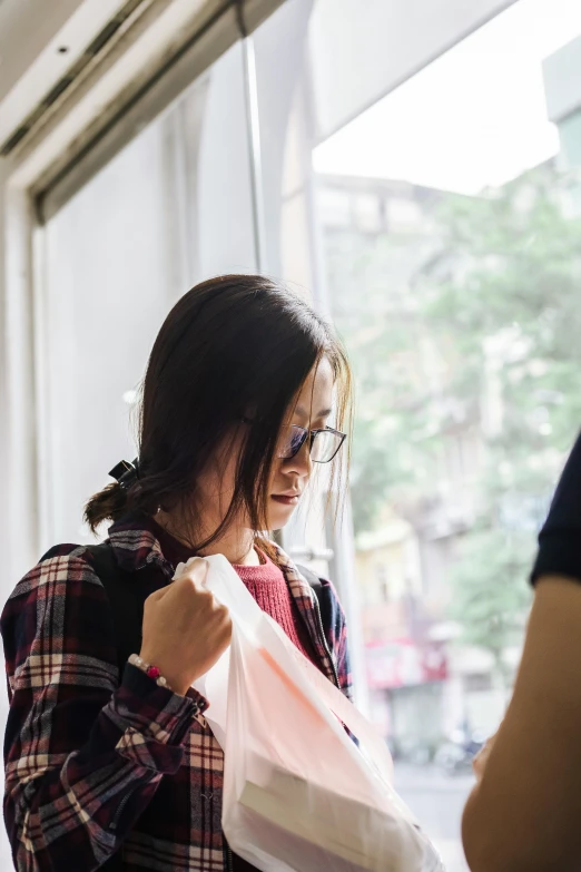 a young lady putting on an unmade shirt