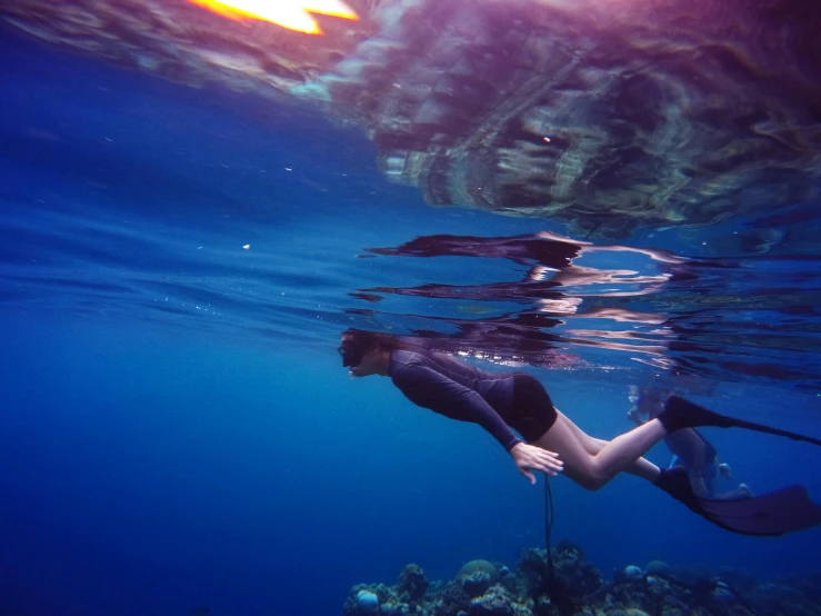 a woman snores with a mask on under water