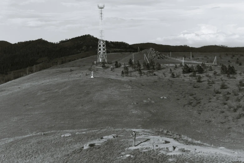 a very tall tower sitting on the top of a hill