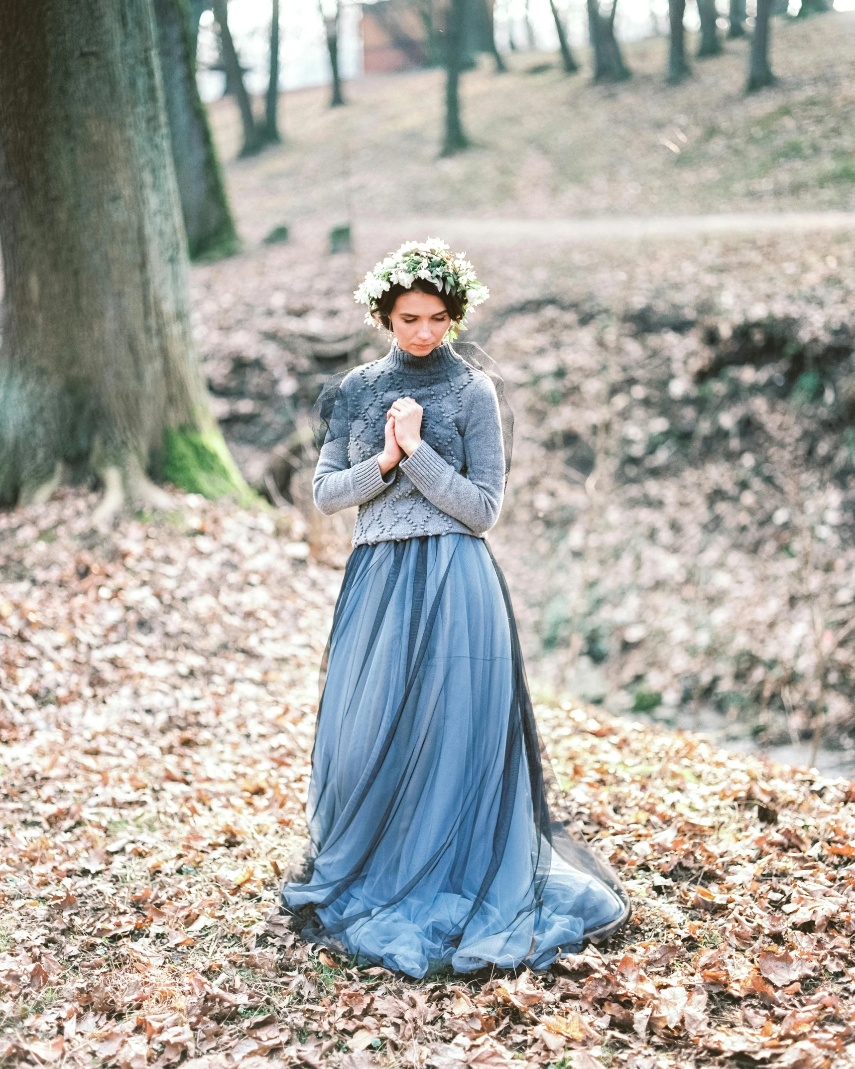 woman wearing a blue dress standing on leaves