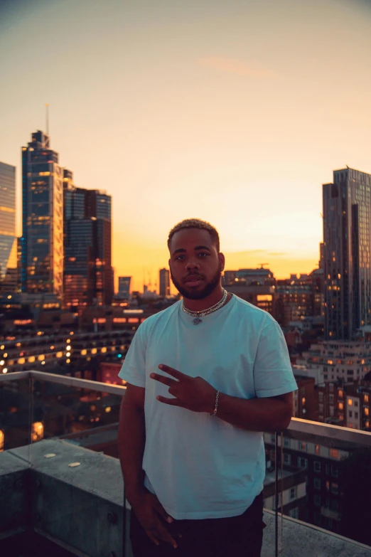 a man holding a string with his hands in a city at sunset