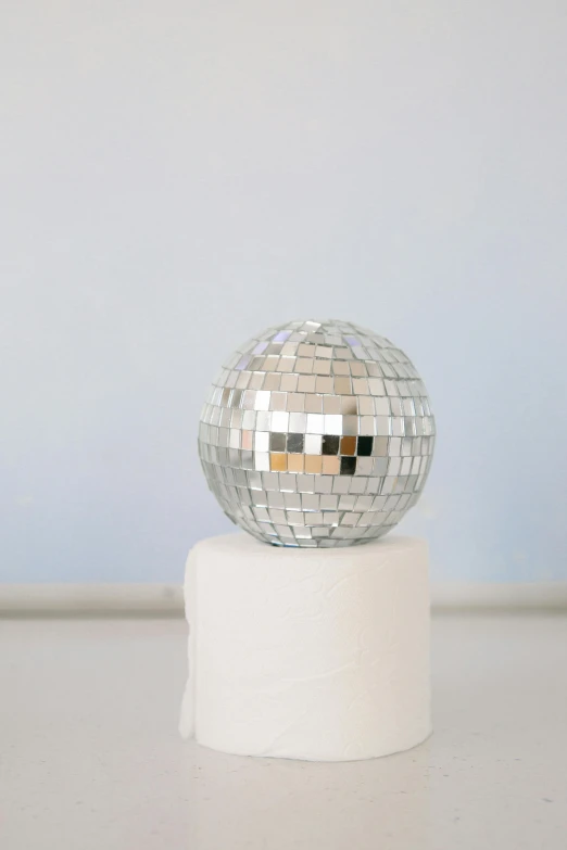 a white sphere on top of a round holder