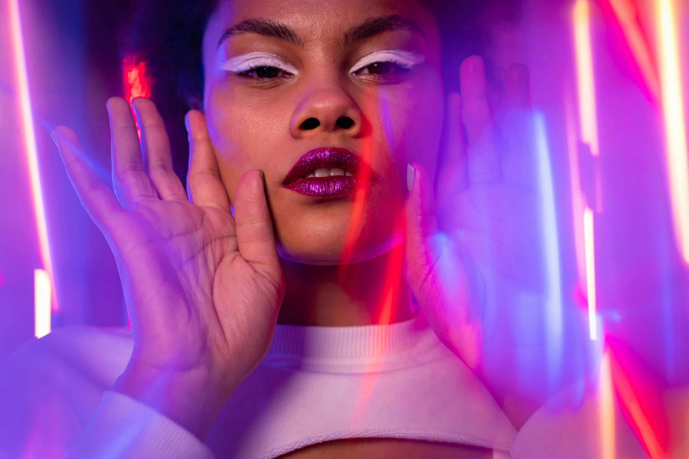 a woman in white shirt posing with light paintings