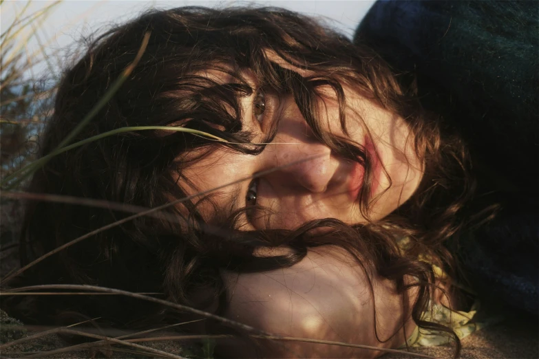 the woman smiles for the camera while laying on her back