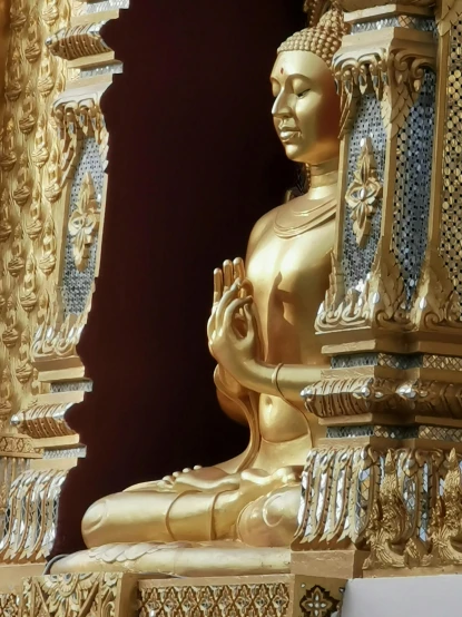 a buddha statue sits inside an open area