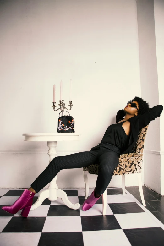 a woman is posing in a chair and she has purple boots