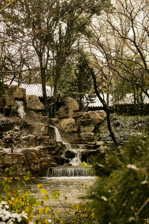 a small waterfall runs into the distance near some trees