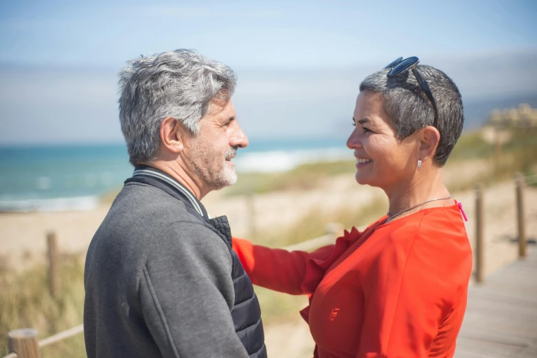 an older couple emcing on the beach