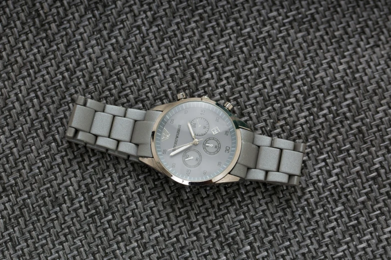 a watch that is laying down on a cloth