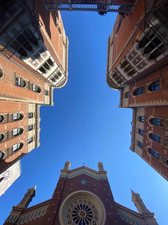 looking up at the steeples of several buildings