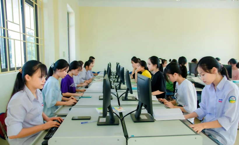 a room full of desks filled with computer monitors