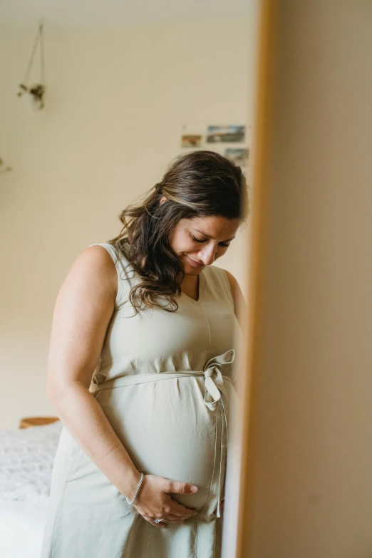 a woman is standing in a room and smiling