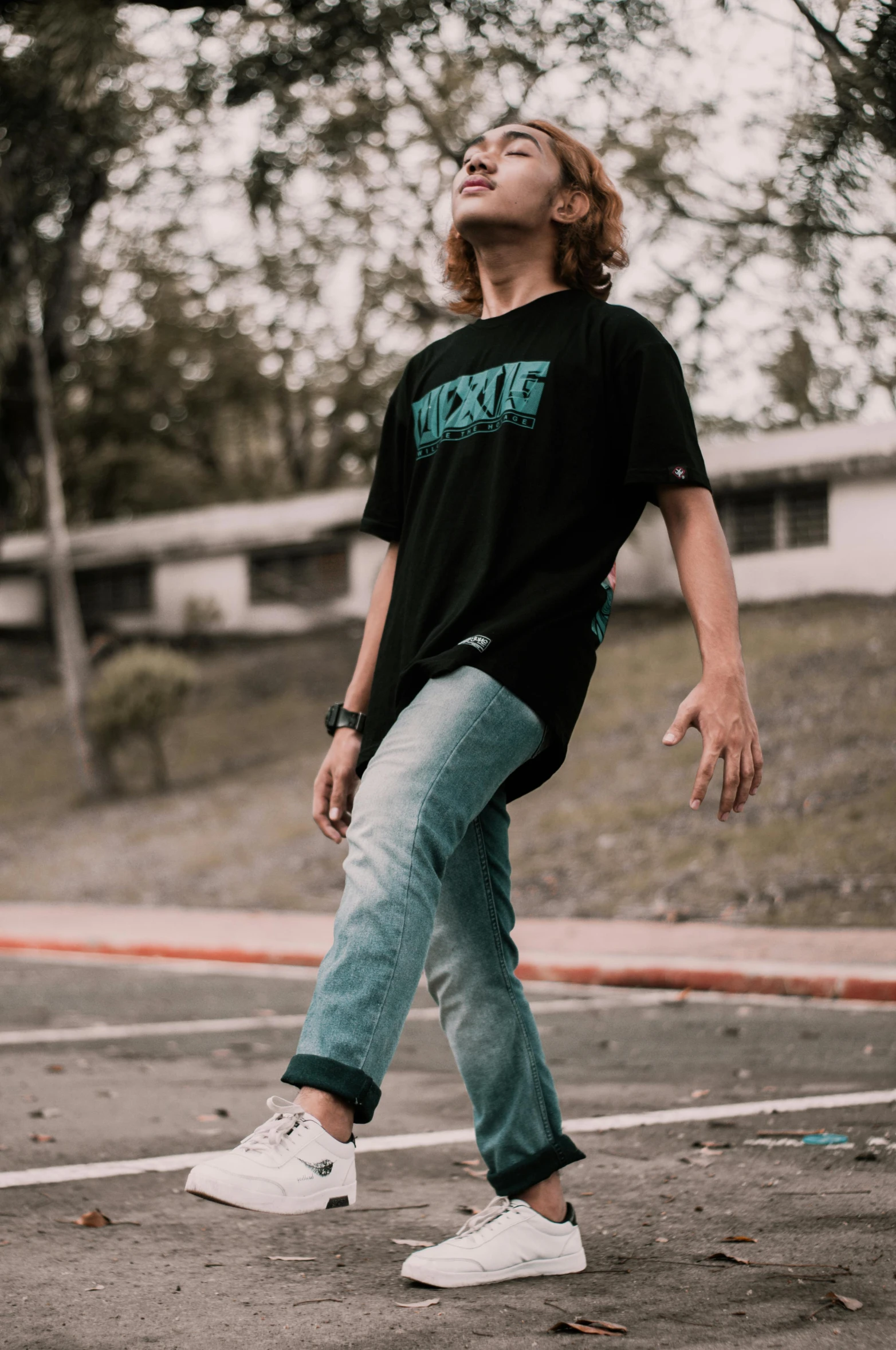 a person standing in a parking lot on the sidewalk