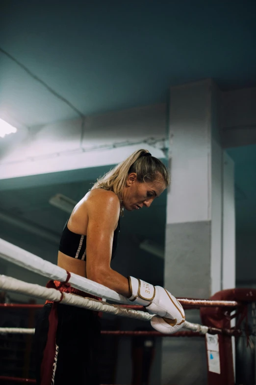 a female boxer holding up her white gloves