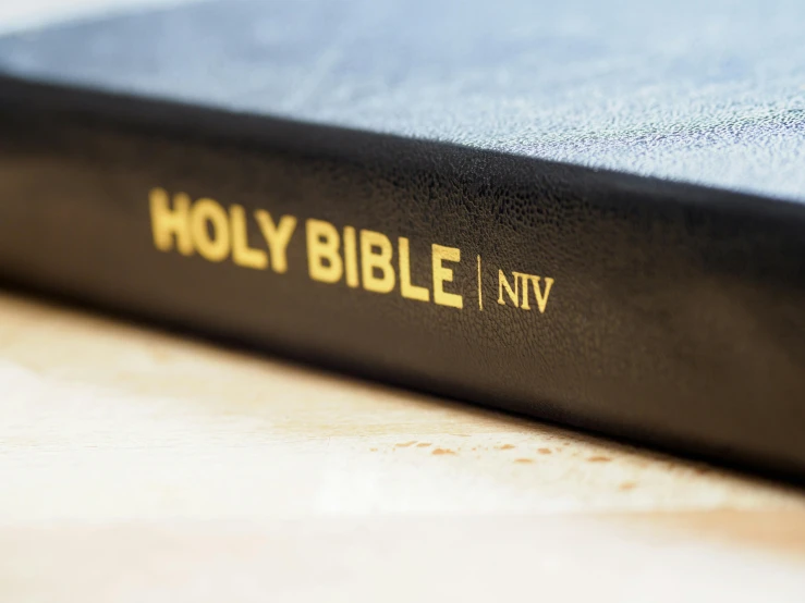 an opened bible sitting on top of a table