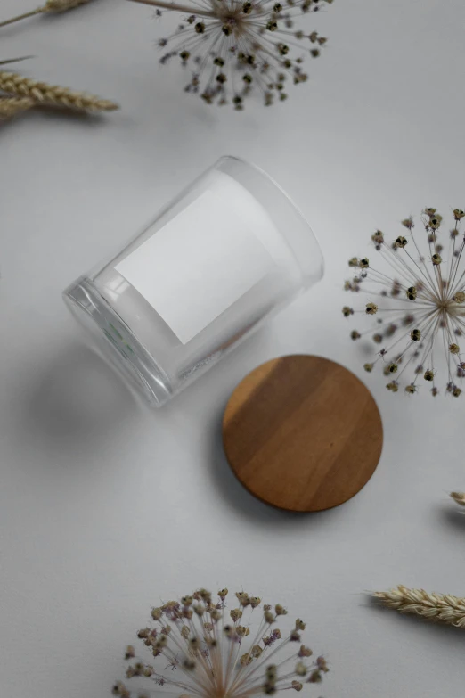 a jar with a wooden lid sitting on top of a table