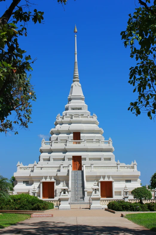 a large white building that is standing in the grass