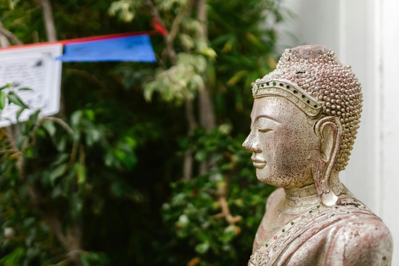 a statue is placed outside by trees