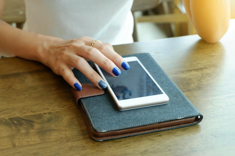 a woman is checking her phone on the tablet computer